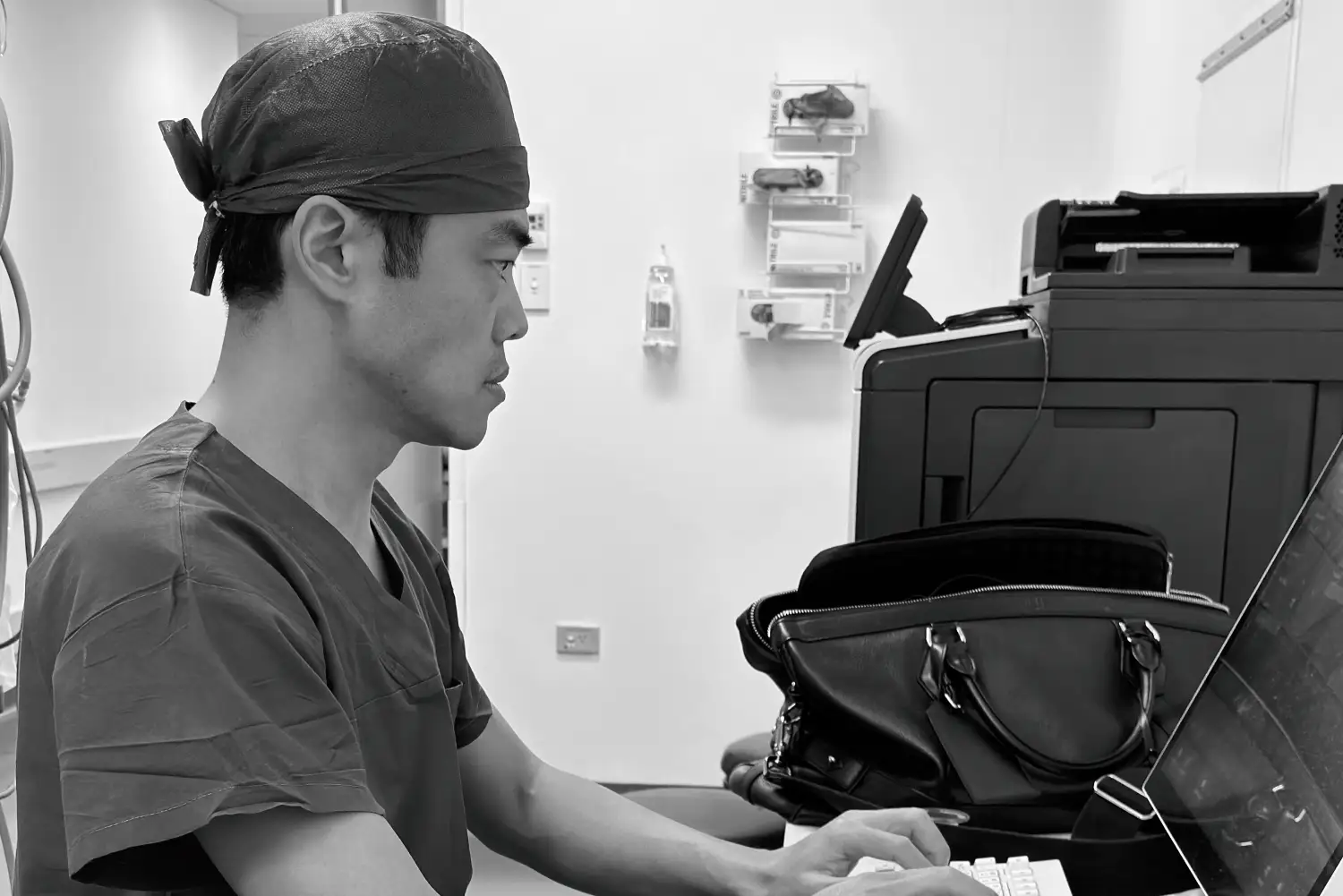 Dr Christopher Cao analysing surgical research and clinical results on computer